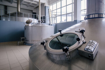 Looking glass of steel tank for beer fermentation in modern brewery