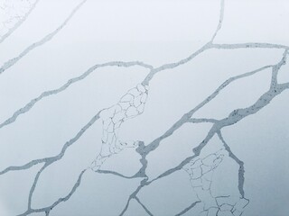 A polished granite marble kitchen surface exudes luxury and elegance, with its smooth, glossy finish and striking patterns, enhancing the aesthetic and functionality of the interior design.