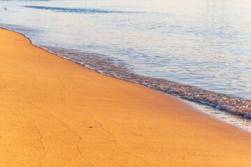 Soft wave of the sea on the sandy beach.