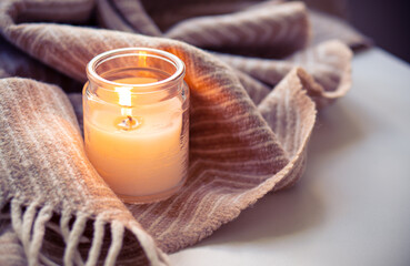 Cozy Candle and Blanket Setup for Enhancing Ambiance and Creating a Serene Atmosphere