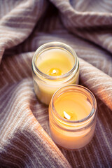 Soft fabric and lit candles create a tranquil and warm atmosphere, promoting relaxation and peace