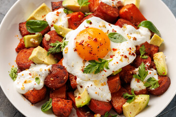 Sweet Potato and Chorizo Hash with egg, avocado and herbs.