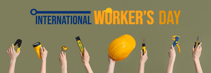 Electrician hands with hardhat and tools on green background