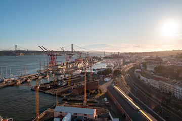 Aerial view of harbor with bridge on background, showcasing picturesque landscape where water meets the citys urban design under a cloudy sky