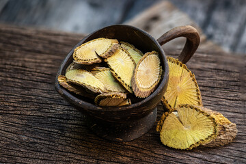 Dried slices Coscinium fenestratum (Goetgh.) Colebr. on an old wooden background.