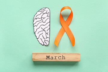 Paper brain with orange ribbon and word MARCH on turquoise background. Multiple Sclerosis Awareness...