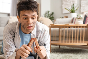 Electrocuted man with burnt face and jumper cables at home, closeup