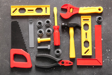 Set of toy tools on grey grunge background. Labor Day celebration