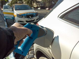 Renewable energy electric car, Taxi recharging energy in the city.