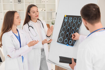 Doctors studying MRI scan at hospital