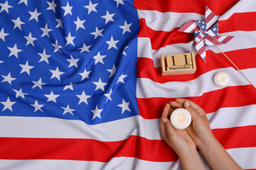 Woman holding burning candle and calendar with date of National Day of Prayer and Remembrance for...