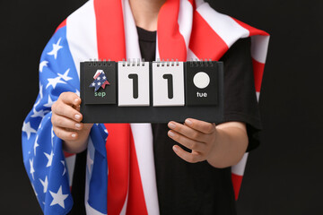 Woman holding calendar with date of National Day of Prayer and Remembrance for the Victims of the...