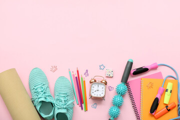 Composition with stationery, sports equipment and shoes on pink background