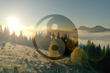 Yin and yang symbol against picturesque mountain landscape