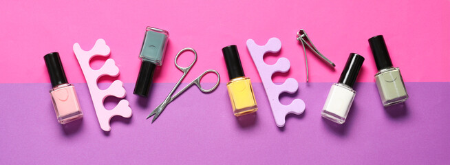 Obraz premium Nail polishes, clippers, scissors and toe separators on color background, flat lay. Banner design