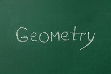 Word GEOMETRY written on green chalkboard