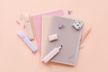 School supplies with markers, eraser and notebooks on beige background. Top view