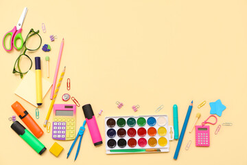 School supplies with scissors, eyeglasses and palette on beige background. Top view