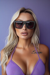 Fototapeta premium Chic Woman in Sunglasses and Purple Bikini Against Purple Background
