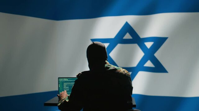 Israel secret police agent uses mass propaganda tools on laptop to influence population minds, engaging in psychological operations. Mossad Israeli spy commits PsyOp sabotage using device, camera B