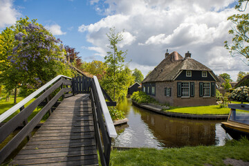 Fototapeta premium Thatched roof homes by the canals in the Giethoorn village , the Netherlands.