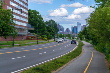 Obraz premium Serene road lined with greenery, leading to the heart of the city, Boston, Massachusetts, USA