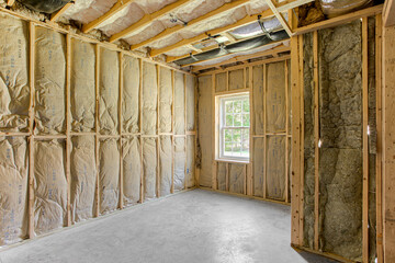 Unfinished Room Showing Insulation And Window With Natural Light
