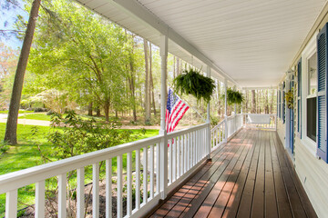 Beautiful Porch With American Flag And Green Garden Background