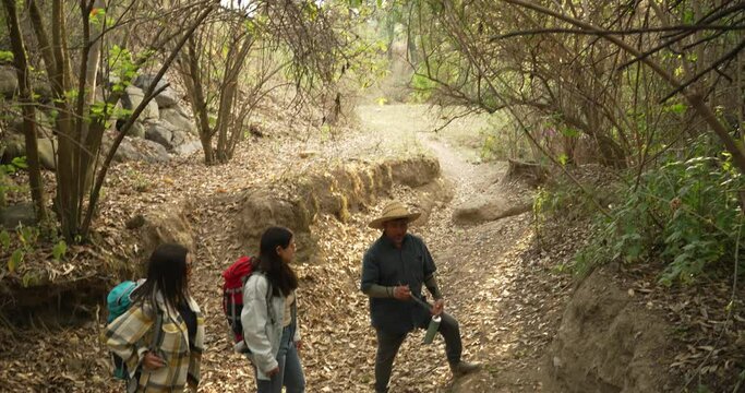 Two mexican girls learn from local guide in San Jeronimo Tecuanipan, Puebla