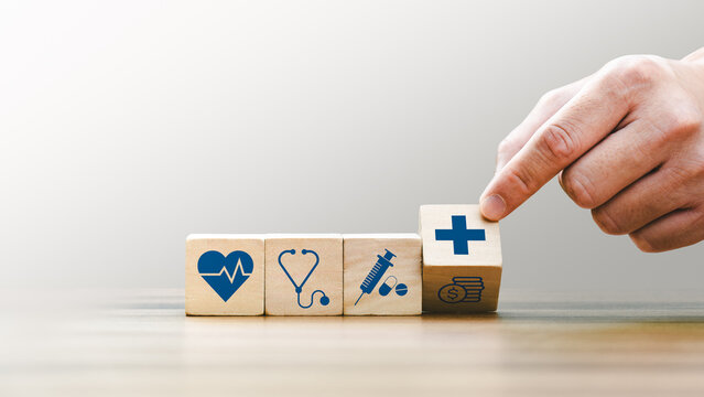Health insurance concept, Hand Arranging Wooden Blocks with Medical Icons Including Heartbeat, Stethoscope, Syringe, and Healthcare Cross Symbol, Future Healthcare Technology - Powered by Adobe