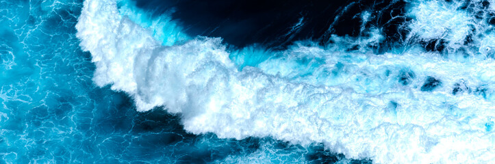 Fototapeta premium Banner Turquoise ocean sea water white wave pattern splashing deep blue sea. Banner Tropical sea beach Seascape dark background wave splash on rock. Summer Ocean Surface big wave with copy space