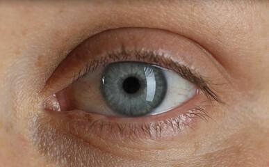 Woman with beautiful blue eyes, macro photo