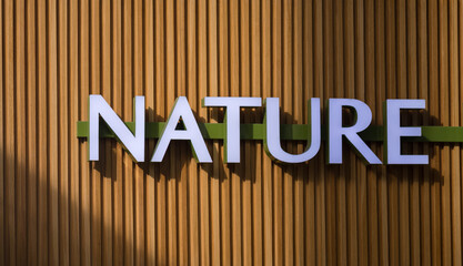White Letters on Brown Wood for an Ecology Backdrop.