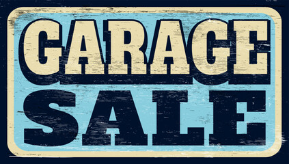 Aged and worn garage sale sign on wood