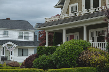 Lush vegetation garden park flowers, bushes, trees in bloom backyard front yard resident mansion house in luxury area in Seattle, Washington with picturesque nature landscape scenery flora