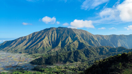 green hills, peaks of Pergasingan hills around Mount Rinjani. its landscape for hiking and outdoor lifestyle concept. beautiful natural scenery