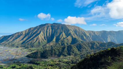 green hills, peaks of Pergasingan hills around Mount Rinjani. its landscape for hiking and outdoor lifestyle concept. beautiful natural scenery