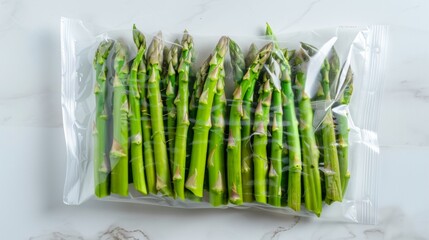 Fresh asparagus vacuum sealed rady for sous vide cooking, isolated on white background, top view.