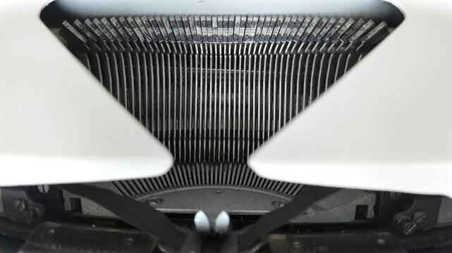 Typing fast on a white typewriter