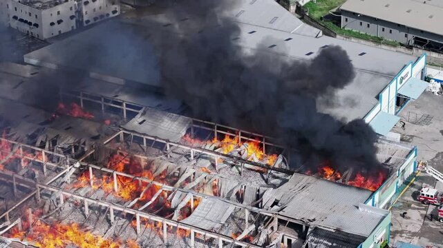 Firefighters spray water on flames ravaging factory in Santo Domingo, drone