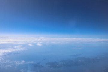 a Clear blue sky with cotton clouds, panoramic view from an airplane,