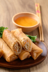 Asian deep fried spring roll filling with cabbage, carrot and glass noodles eating with dipping sauce 