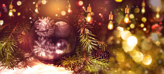 Christmas still life with branch of Christmas tree and Christmas decorations, glittering lights,  vintage bauble. New Year banner. Happy holiday