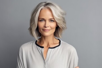 Fototapeta premium Portrait of a beautiful middle-aged woman with grey hair.