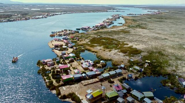 Panoramic aerial establishing dolly of Uros Island floating homes on Lake Titicaca