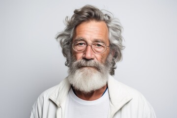 Fototapeta premium Portrait of senior man with grey beard and glasses. Studio shot.
