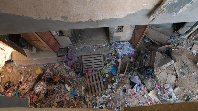 Damaged building rubbles and plastic bottle waste during Israel Hamar civil war conflict