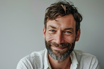 Portrait of a handsome bearded man looking at the camera with a smile