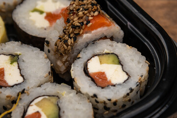 Sushi roll with salmon rice fried sweet potato cheese seaweed delivery