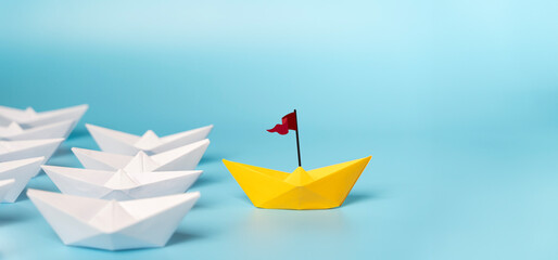 Leadership Concept with Paper Boats. Set of colorful origami ships on blue background.